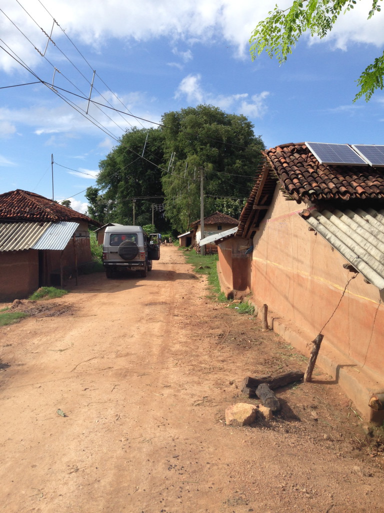 A Defunct grid electrification sits side by side community-owned solar minigrids